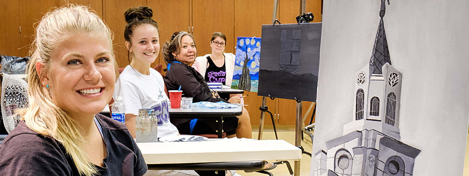 four female students in painting class