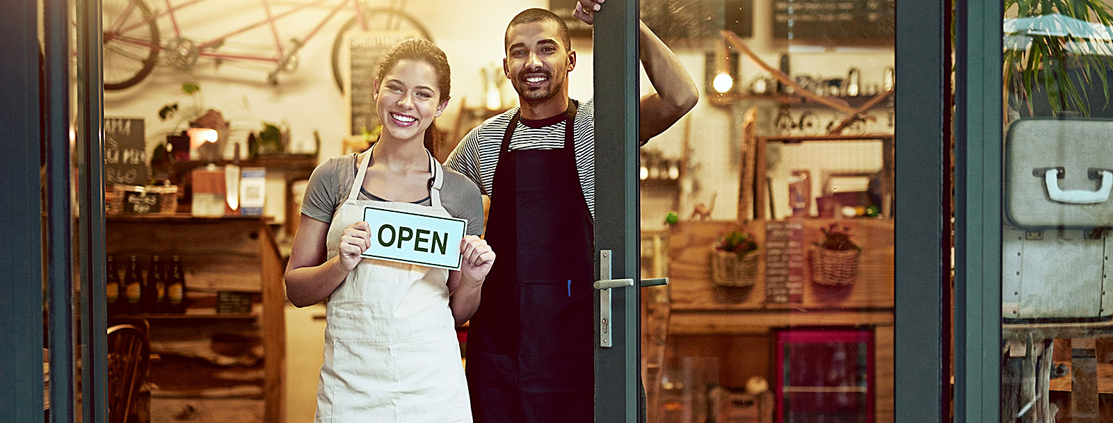 man and woman standing in doorway of new business