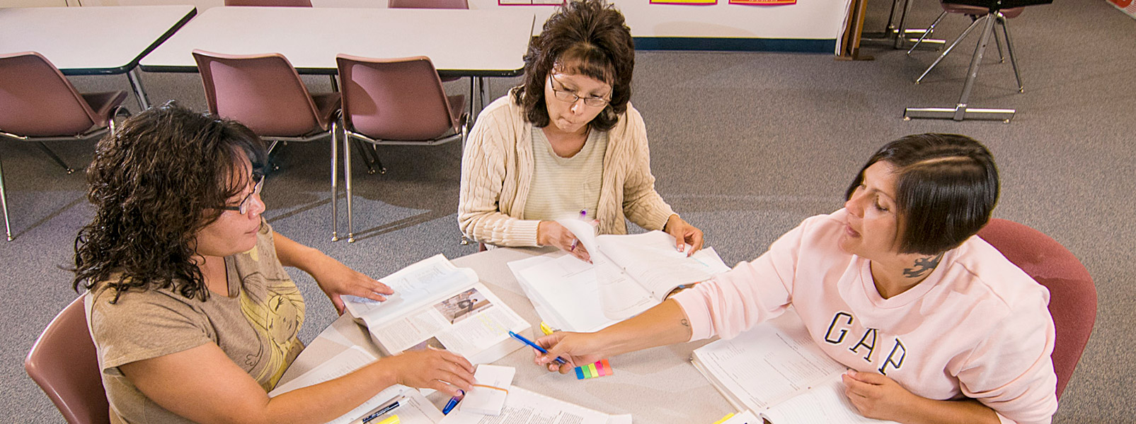 three adult students studying