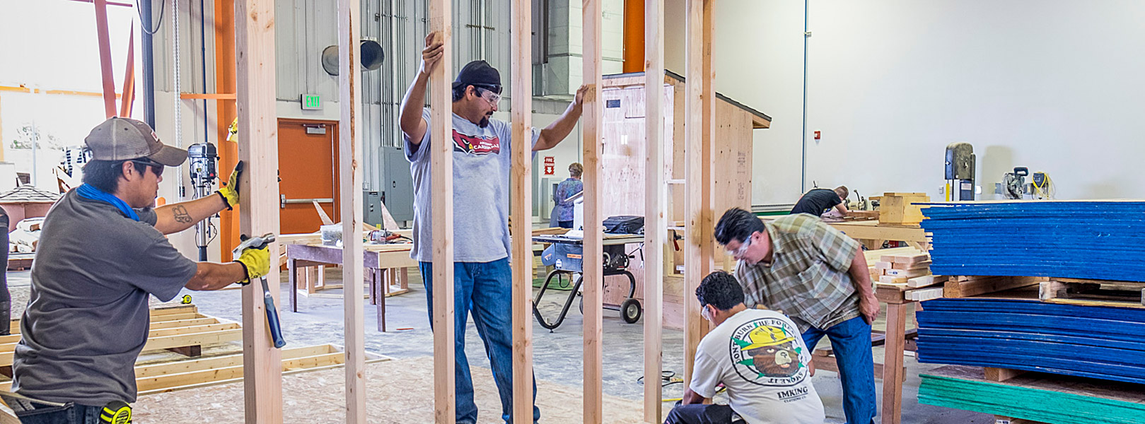 students working on wall framing