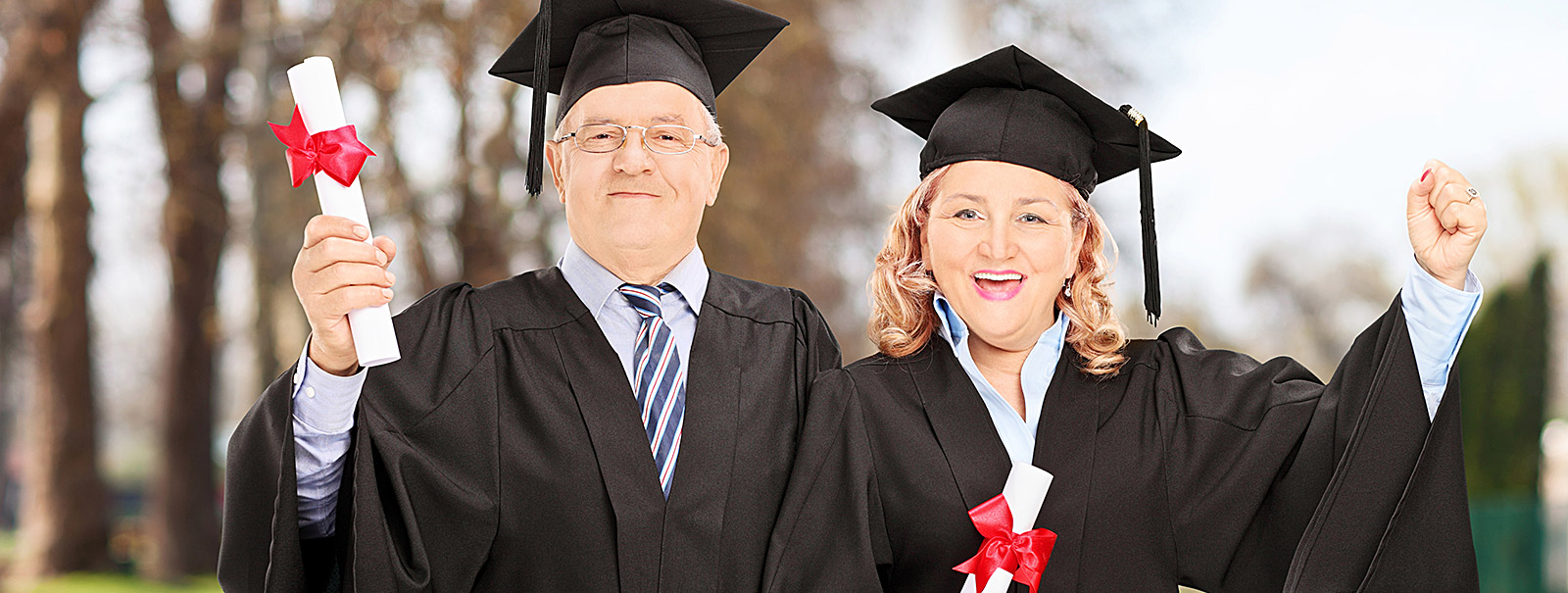 adult students holding diploma