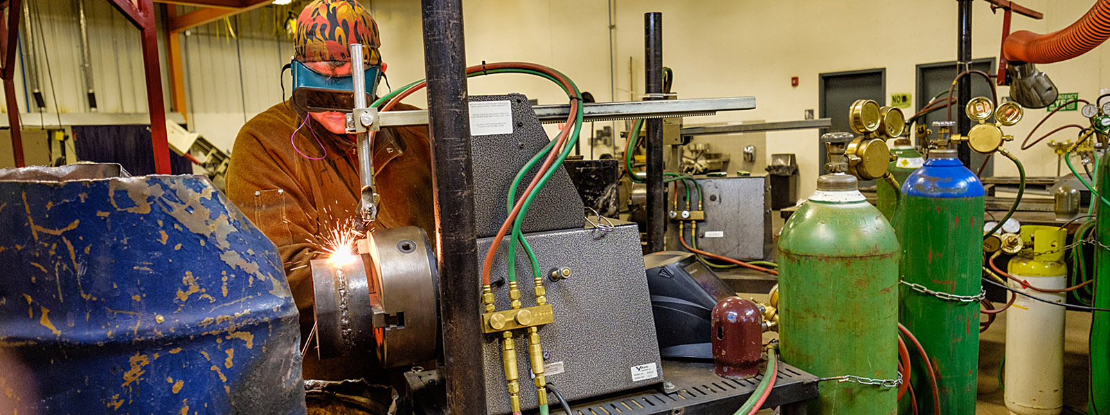 man grinding in welding lab