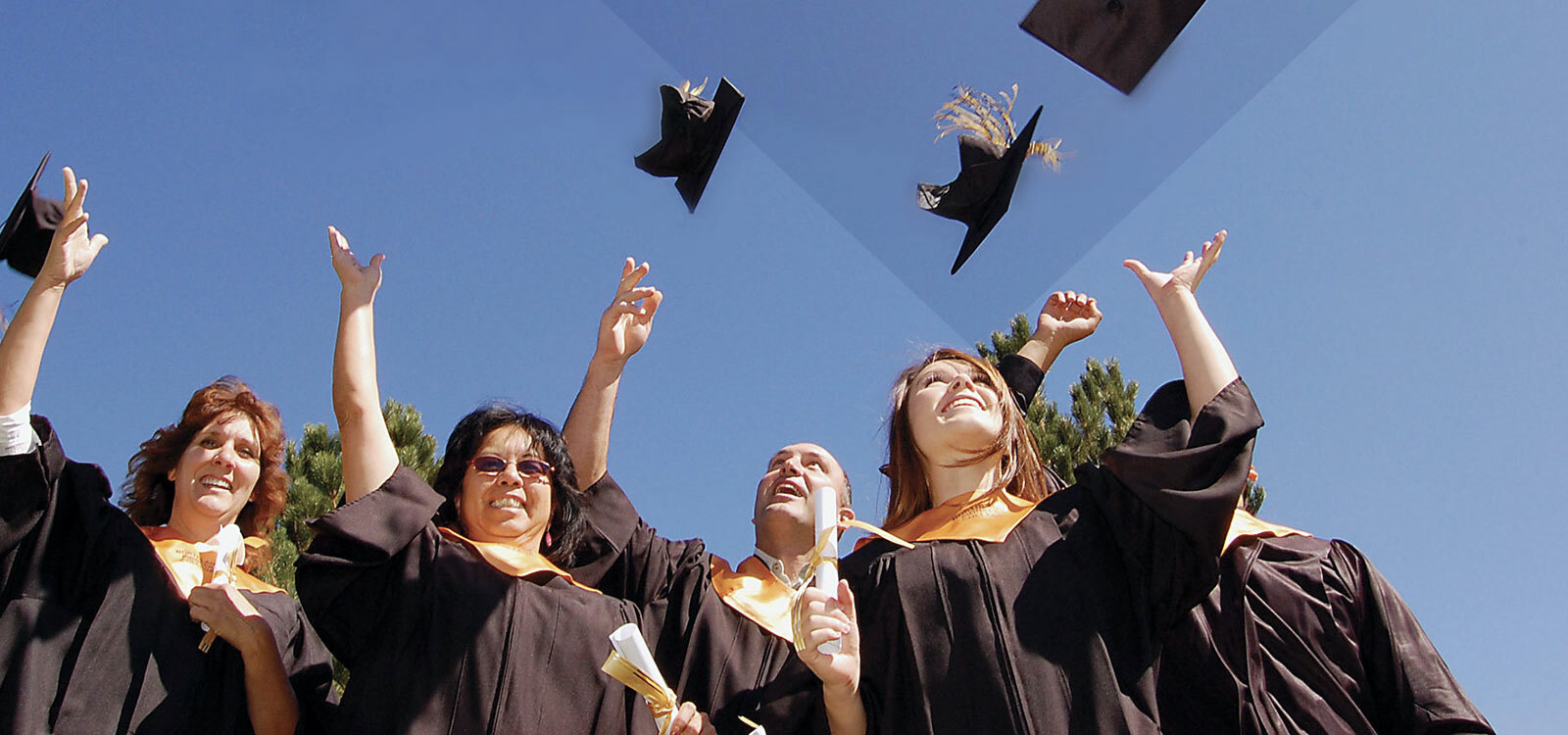 Graduates throwing caps in the air