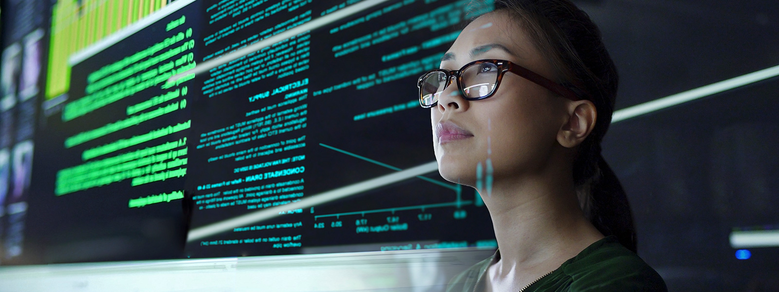 Woman looking at code on computer screen