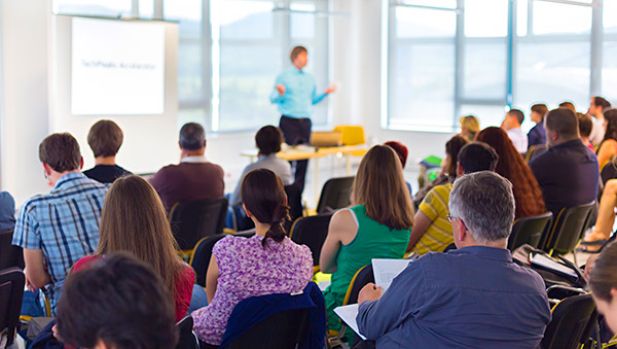 workers listening to trainer in room