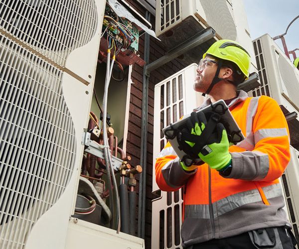HVAC Technician inspecting building