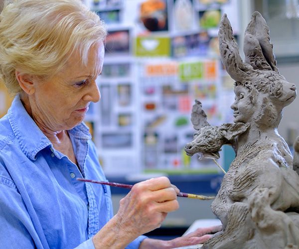 woman working on sculpture