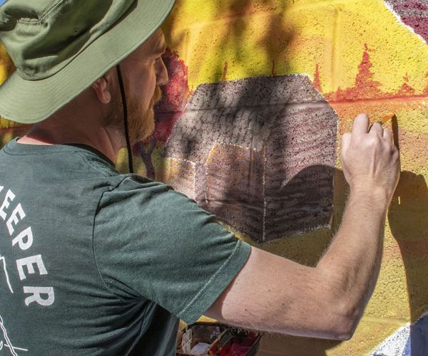 Student painting a mural