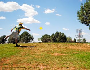 Disc Golf Player Makes a Putt