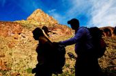 blind person being guided on a hike