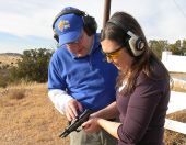 Richard Harris works with a student during one of his noncredit gun safety classes