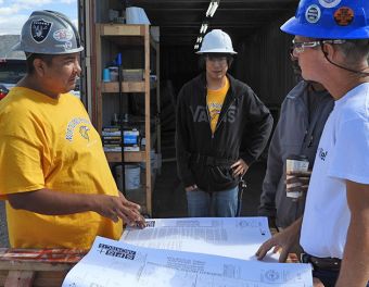 Vaughn Willeto discusses the tiny home plans with instructor Steve Mills.