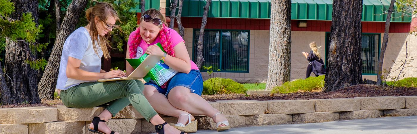 students outside on campus working